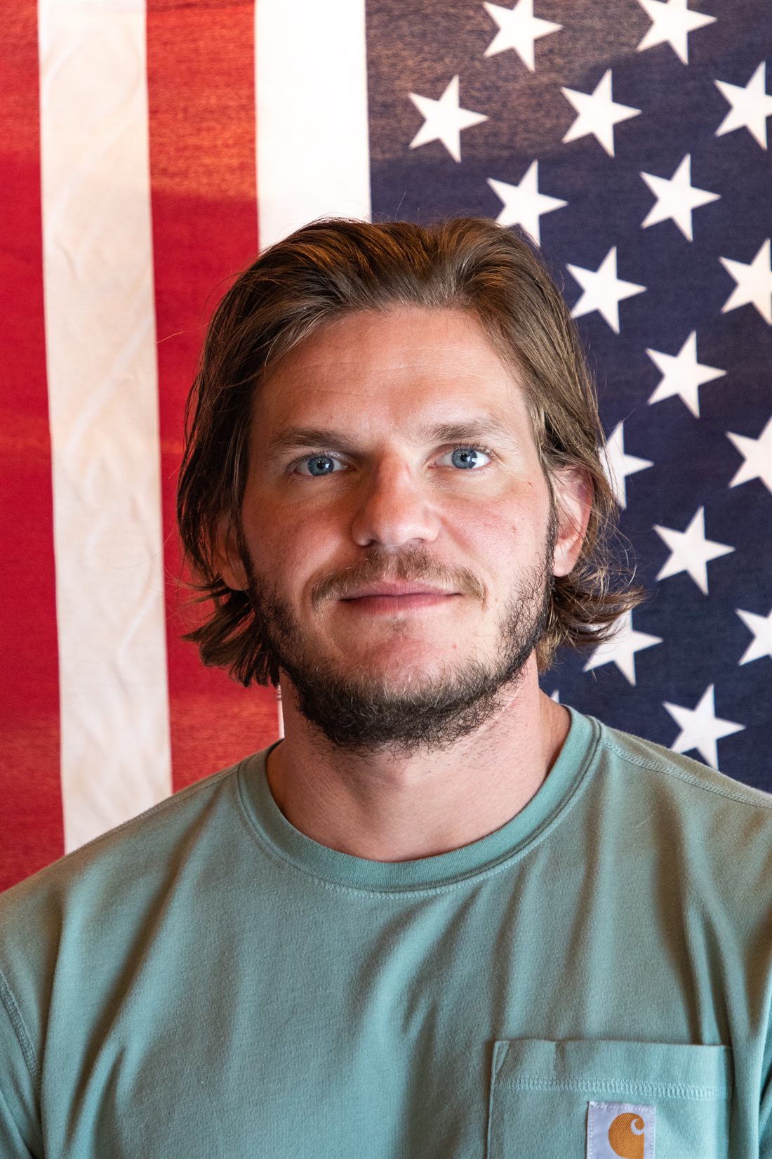 Ryan in front of an American flag